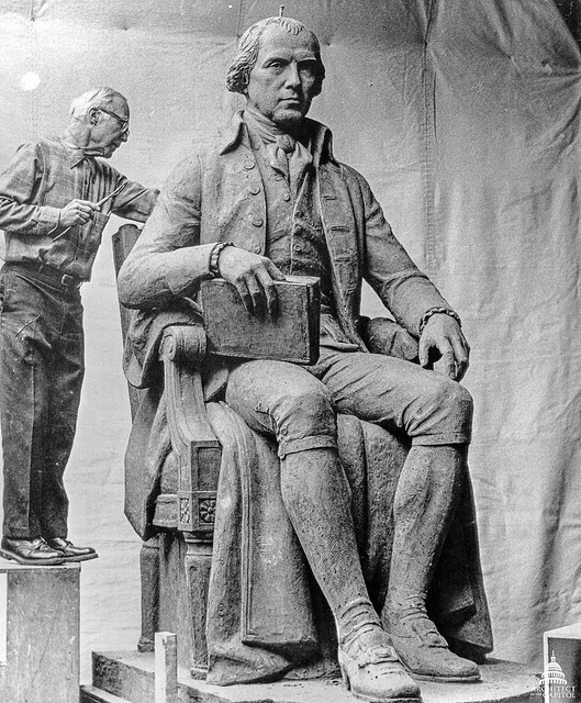 Sculptor Walker Hancock with his statue of James Madison.