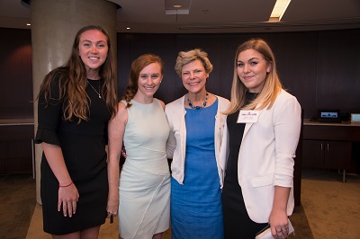 Maggie Collines, Allison Ford, and Sophie Black from United Technologies pose for a photo with Cokie Roberts.