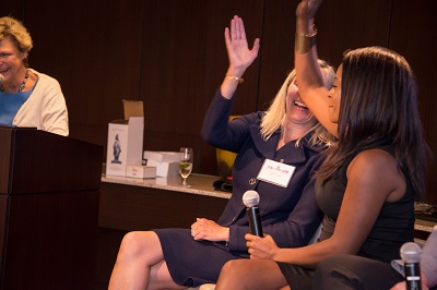 Muffy Day and Rhonda Foxx high five as they both serve as Chiefs of Staff to female Members of Congress.