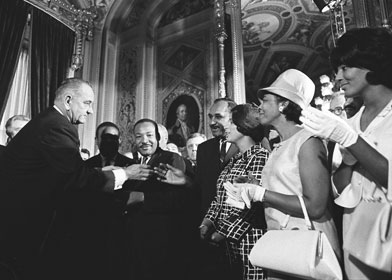 President Lyndon B. Johnson signed the
1965 Civil Rights Act in the Capitol on August 6. Here, he is about to shake hands with Clarence Mitchell, who is standing with Rev. Martin Luther King, Jr. and other civil rights leaders.

Credit: LBJ Library photo by Yoichi Okamoto